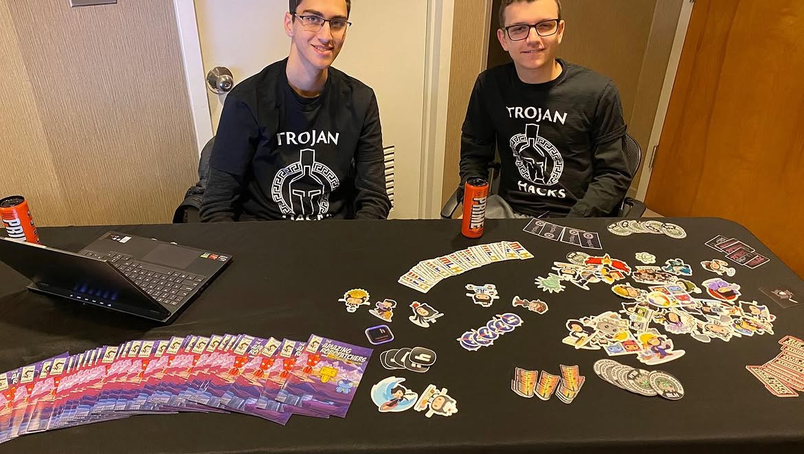 Trojan Hacks volunteers with stickers